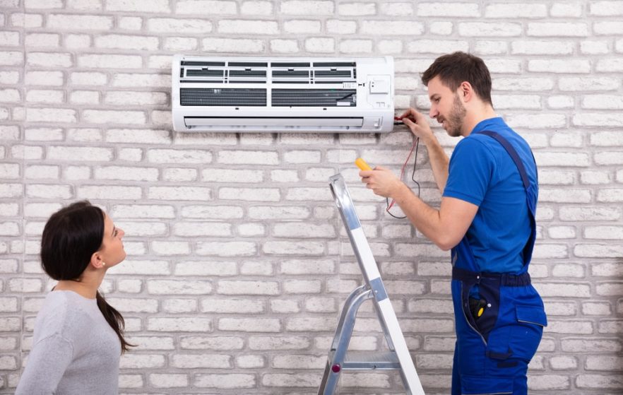Air Conditioner Repair Man Using Checking for Faults — Heating & Cooling in Orange NSW