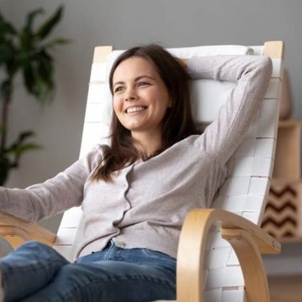 Smiling Woman Relaxing in an Air Conditioned House — Heating & Cooling in Central West NSW