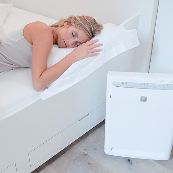 Woman Sleeping with Air Purifier Beside the Bed — Heating & Cooling in Central West NSW