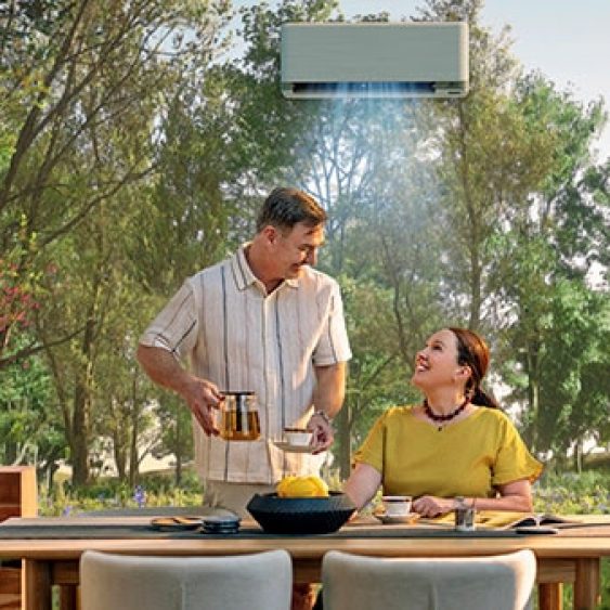 A Couple Sitting At An Outdoor Table