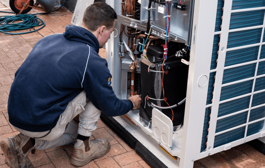 A Man Fixing The Air Conditioner